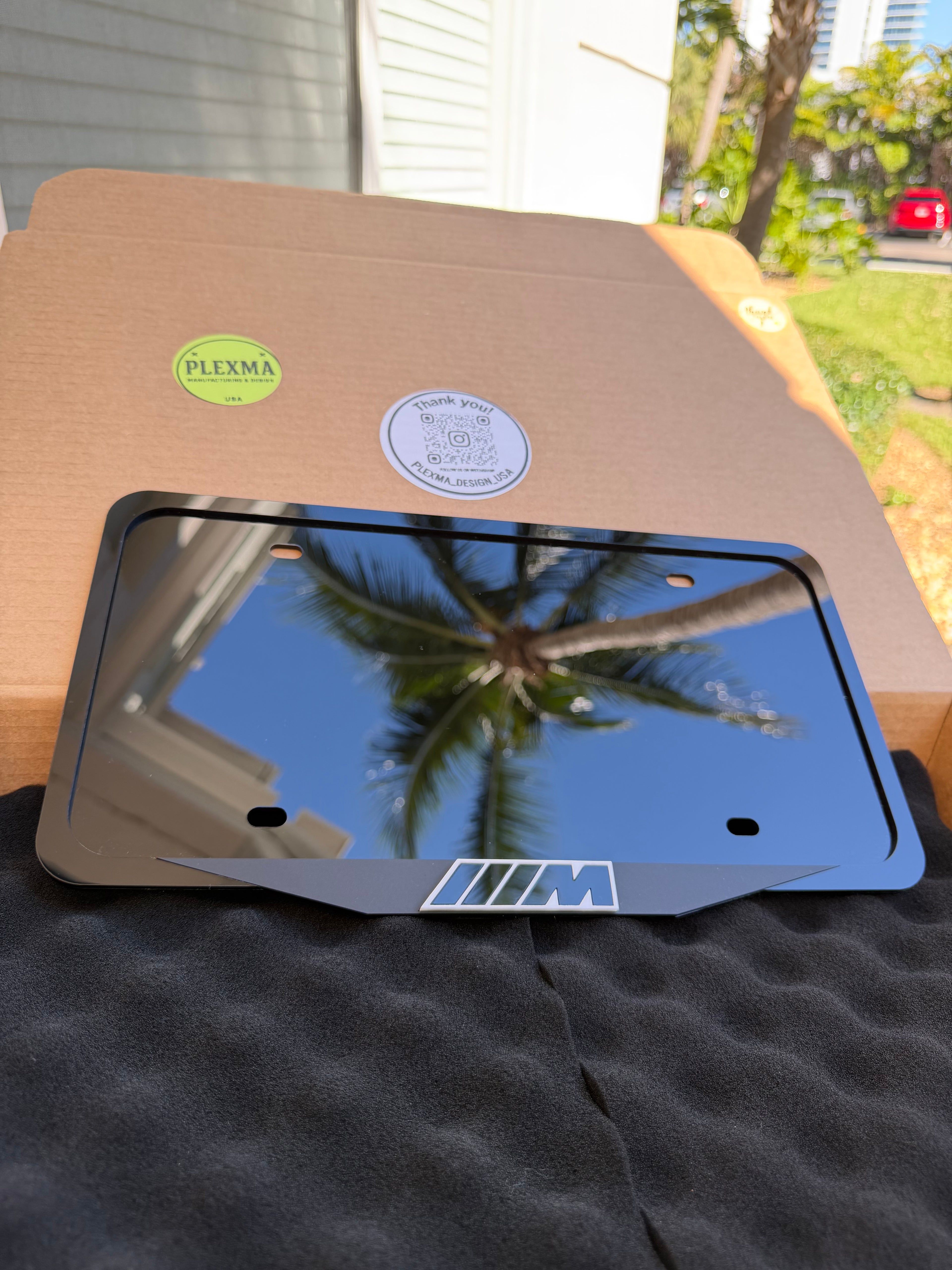 Custom BMW M performance license plate frame with raised 3D logo black acrylic