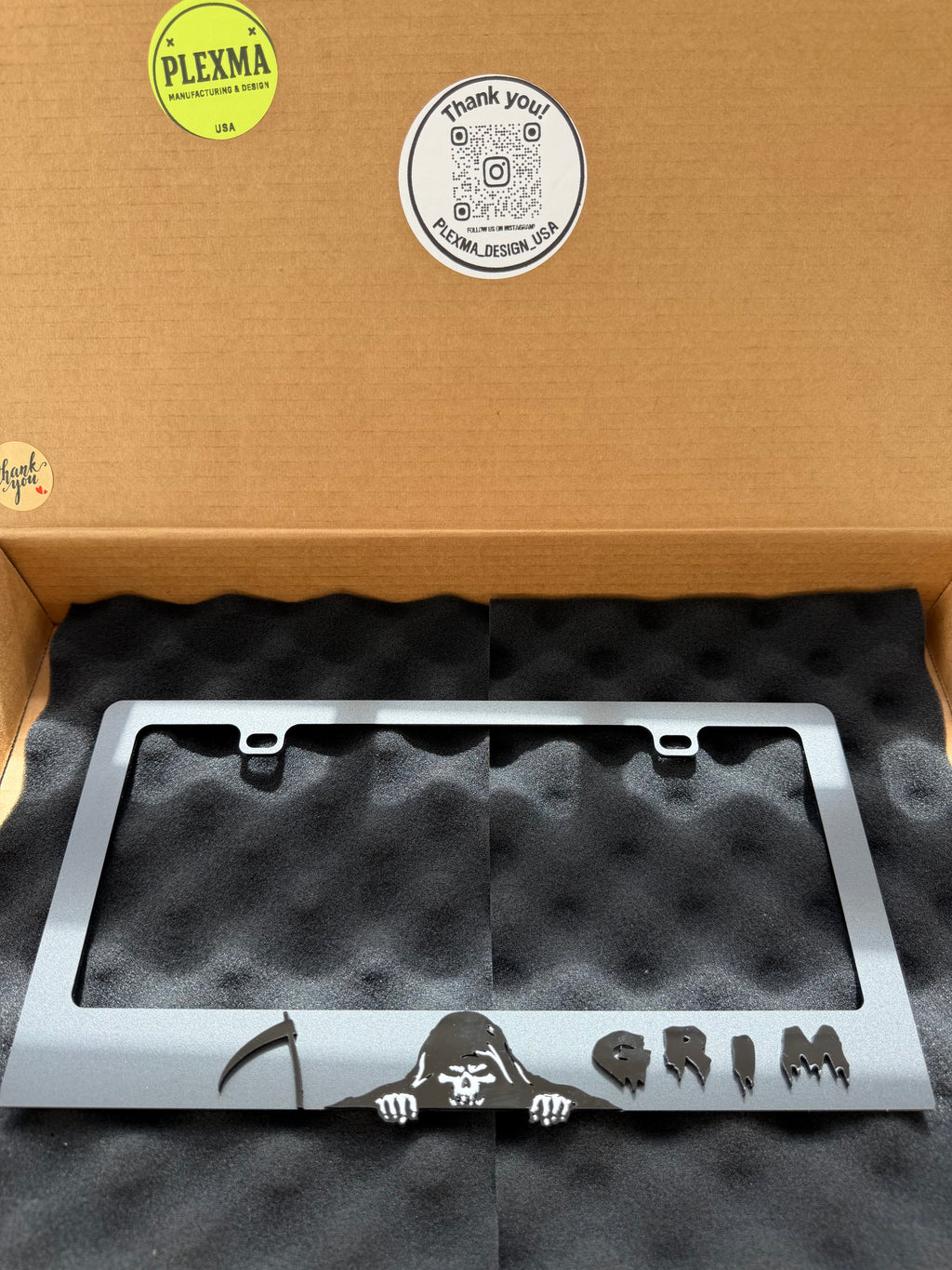 Grim Reaper skull 3D license plate frame in glossy black acrylic for vehicles