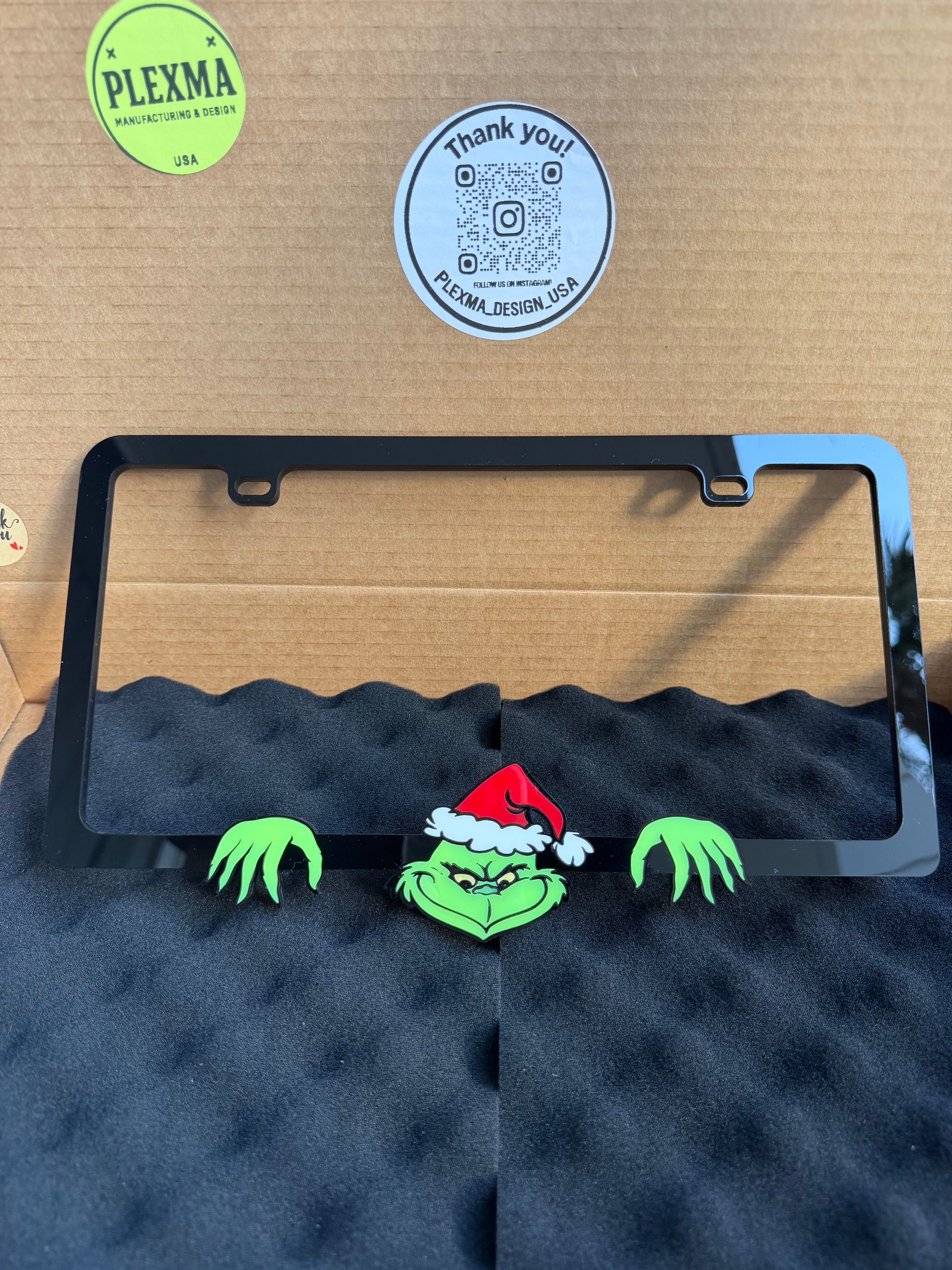 Grinch 3D black acrylic license plate frame with raised logo, handmade in USA