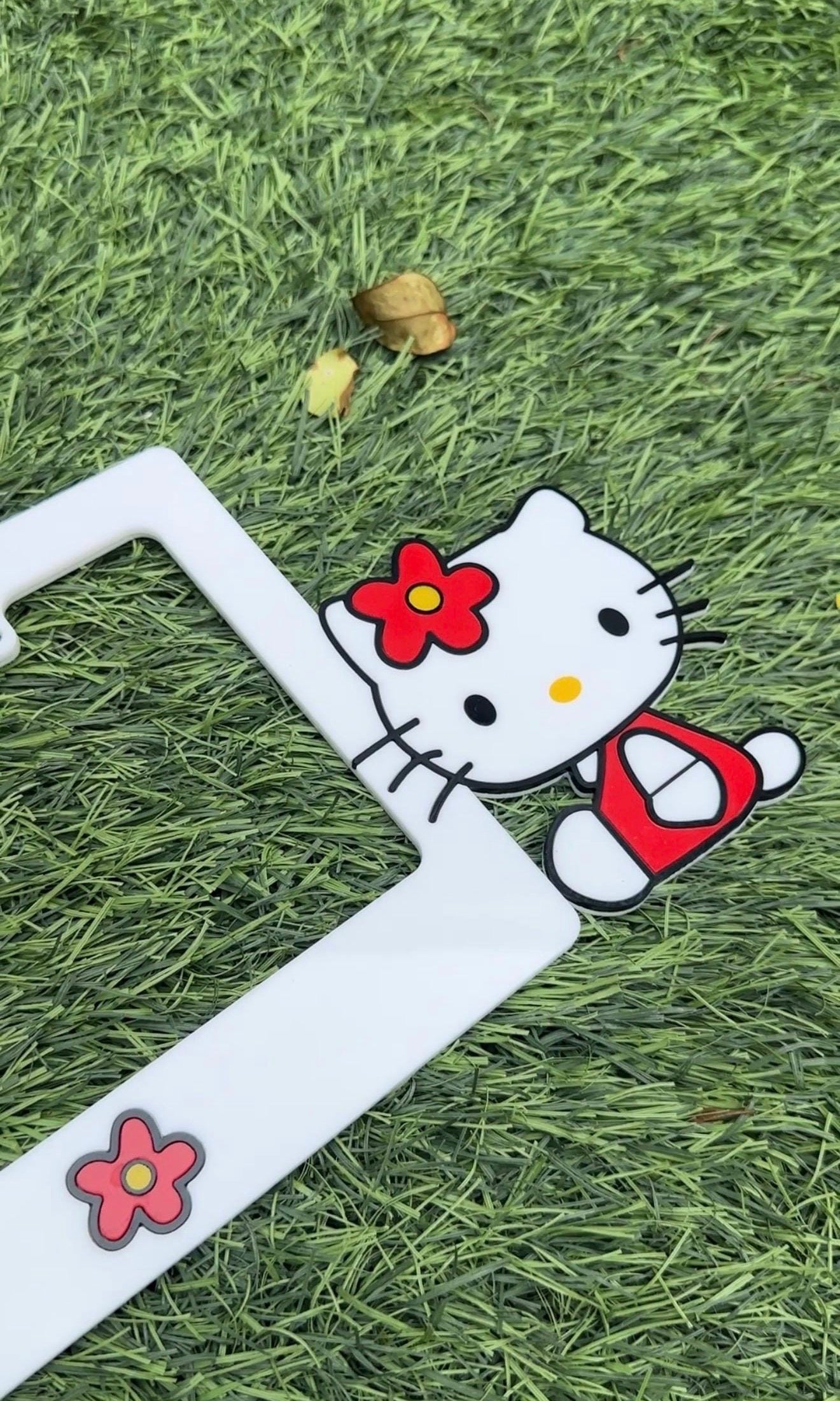 Hello Kitty 3D black acrylic license plate frame with raised logo, handmade in USA