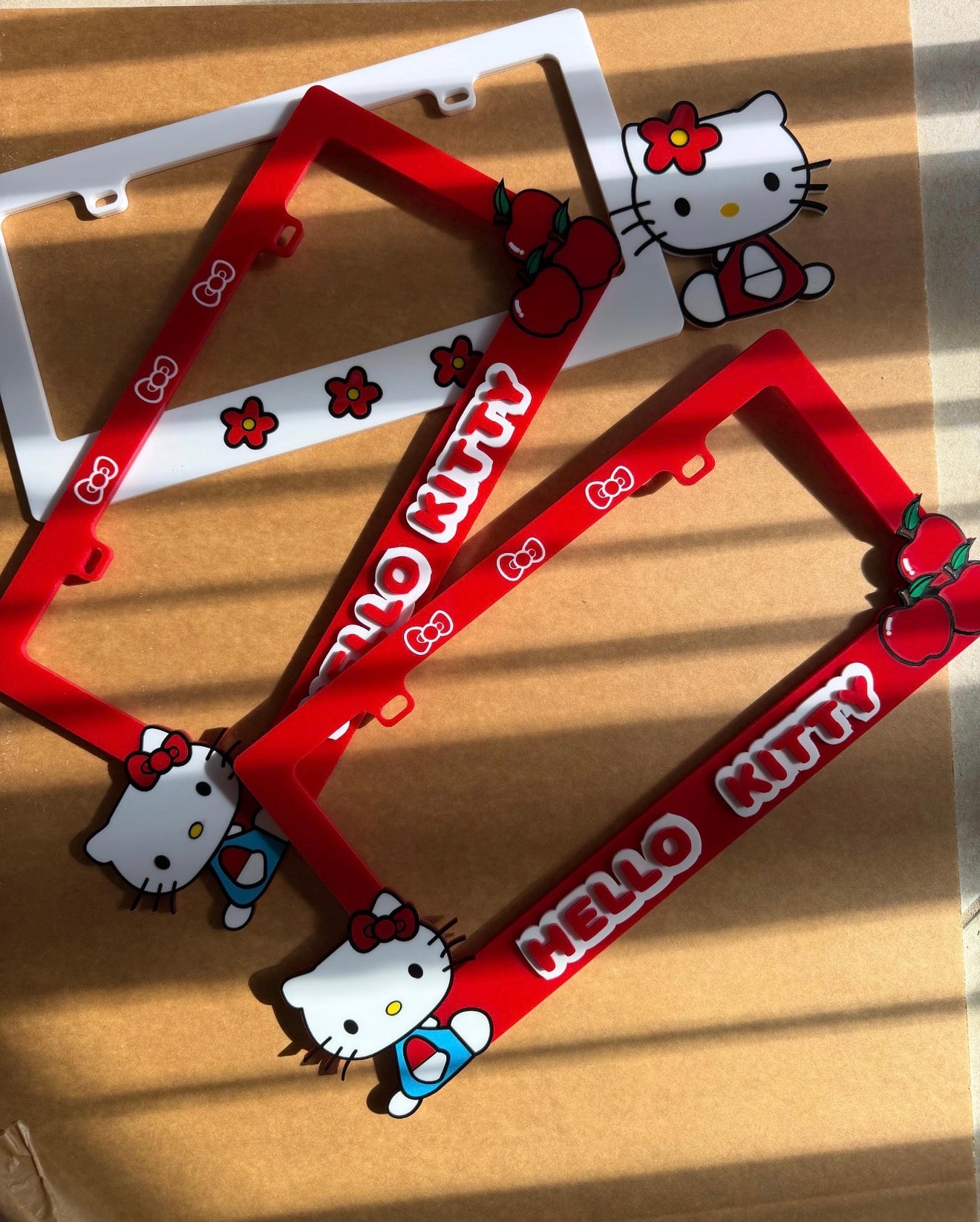 Hello Kitty kawaii license plate frame with 3D emblem, black acrylic car accessory